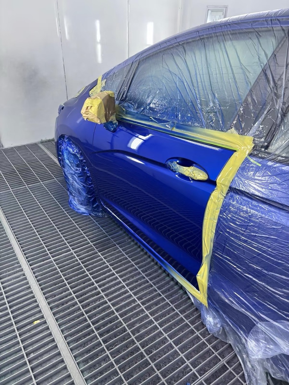 Blue Honda hatchback after repair